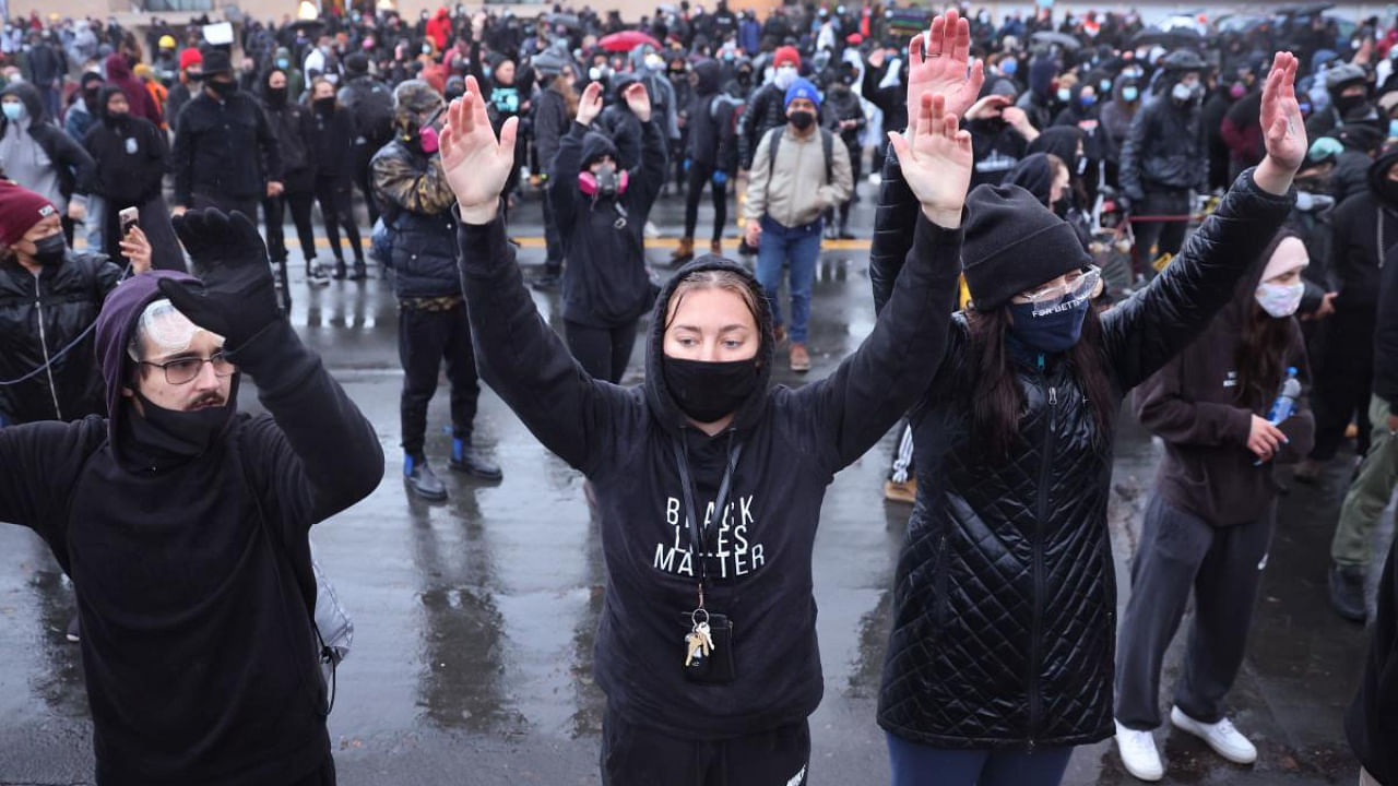 Demonstrators face off with police outside of the Brooklyn Center police station on April 12, 2021 in Brooklyn Center, Minnesota. Credit: AFP photo. 