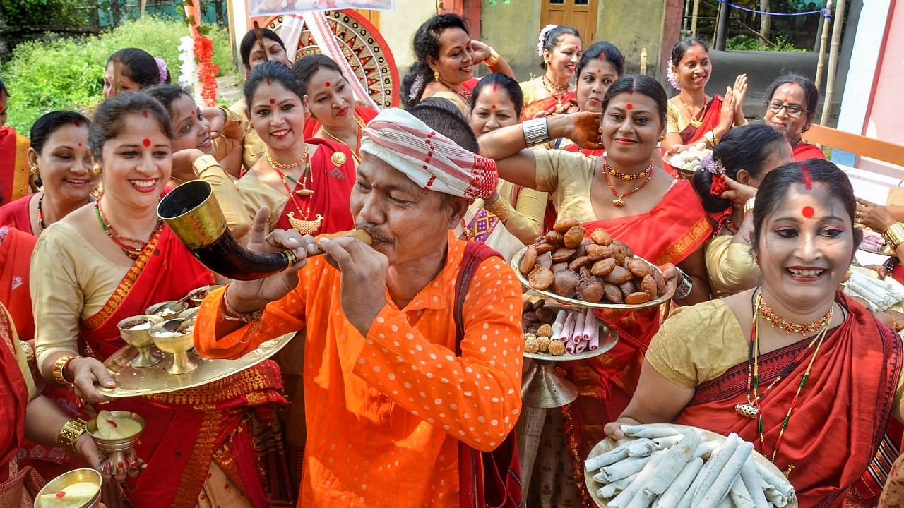 Women perform 'Uruka' rituals on the occasion of 'Rongali Bihu' festival, at Tezpur in Sonitpur district. Credit: PTI Photo