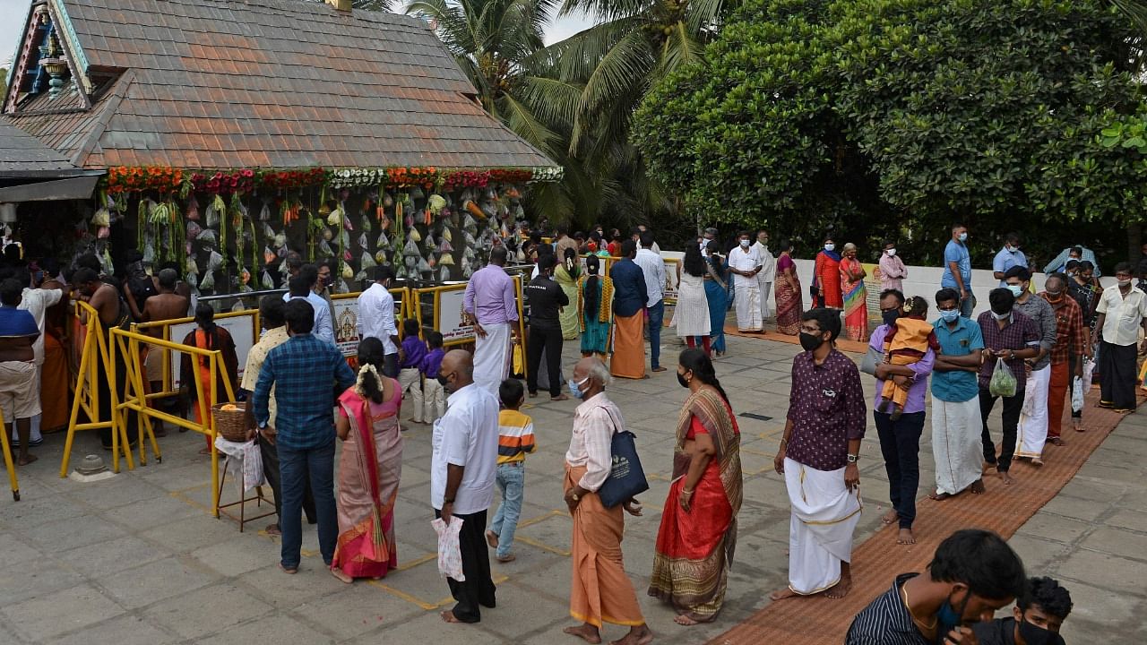 A large number of people thronged temples across the state to have the glimpse of 'vishukani' arranged there since wee hours. Credit: AFP Photo
