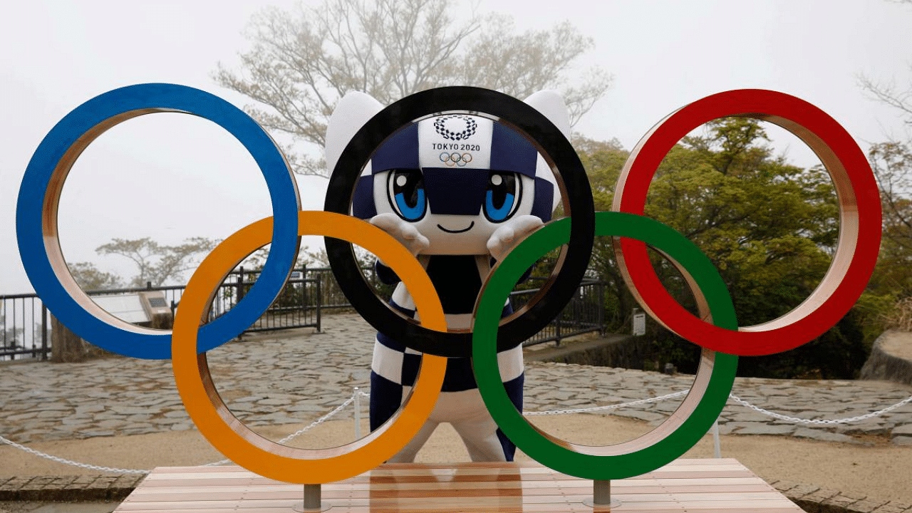 Tokyo 2020 Olympic Games mascot Miraitowa poses with a display of the Olympic Rings after an unveiling ceremony of the symbol on Mt. Takao in Hachioji, west of Tokyo. Credit: AFP photo. 