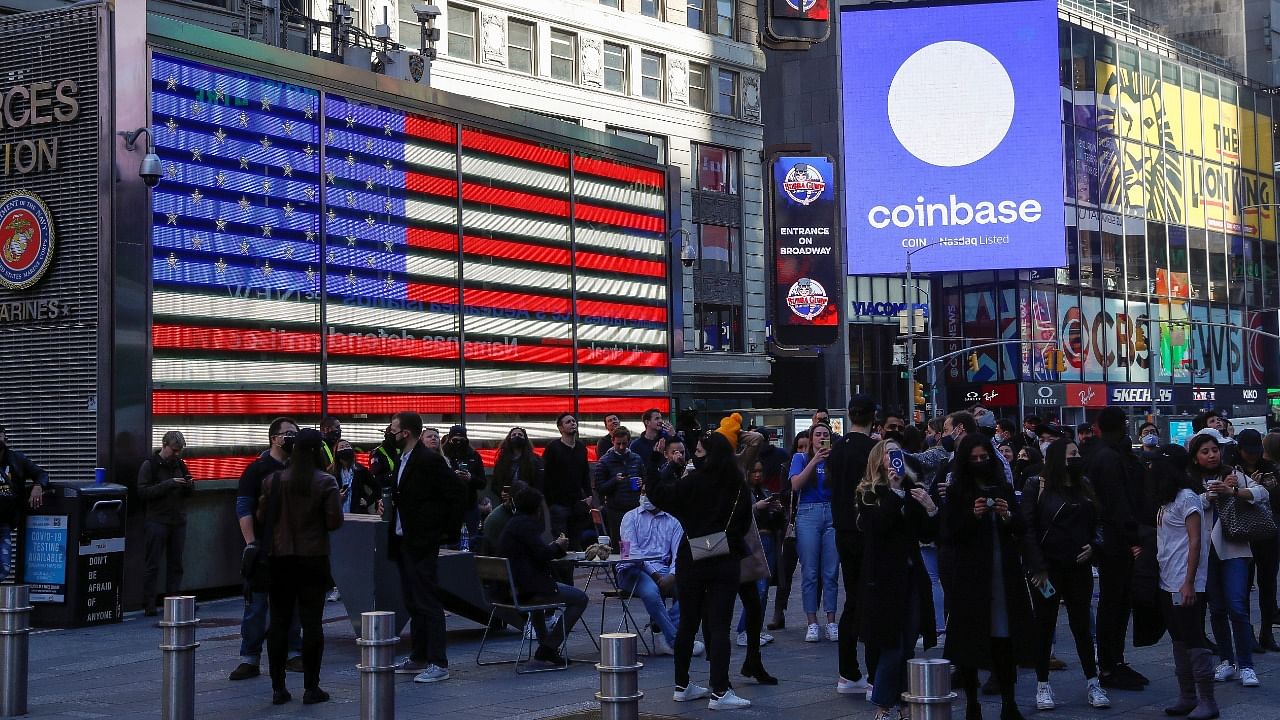 Employees of Coinbase Global Inc, the biggest US cryptocurrency exchange, watch as their listing is displayed on the Nasdaq MarketSite jumbotron at Times Square in New York. Credit: Reuters Photo