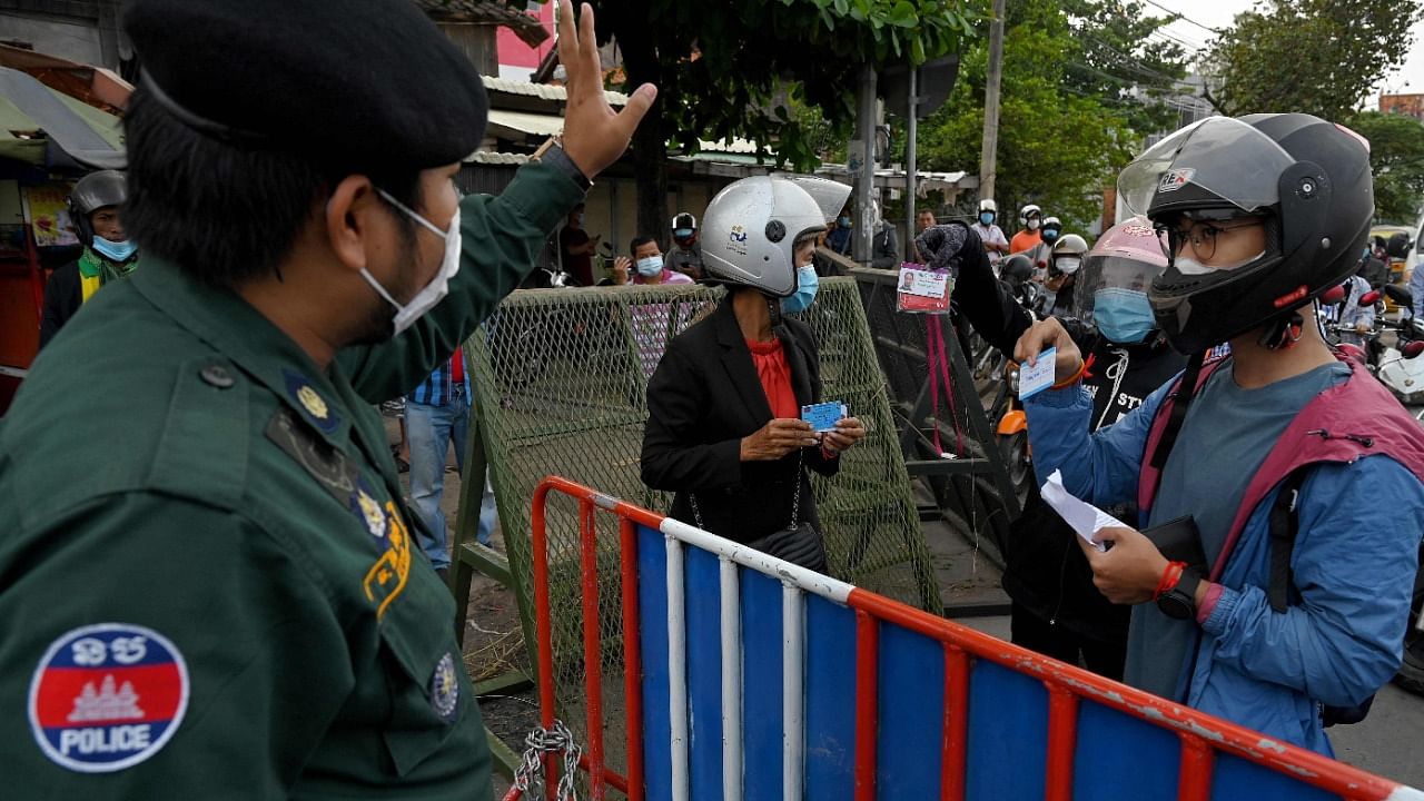Police manning checkpoints on Thursday in Phnom Penh asked motorists to show work documents and identity cards in order to pass. Credit: AFP Photo
