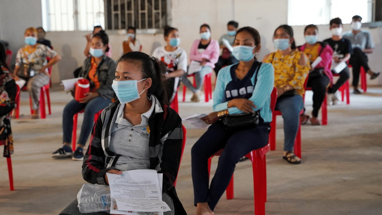 Garment factory workers and staff wait to receive China's Sinovac coronavirus vaccine at an industrial park in Phnom Penh, Cambodia, April 7, 2021. Credit: Reuters Photo