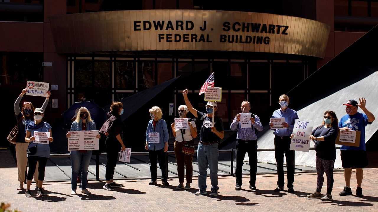 Demonstrators from Indivisible groups protest, what they claim is, Republican voter suppression and votings rights as they demand the passage of S1, the "For the People Act," intended to protect voting rights for all Americans. Credit: Reuters photo