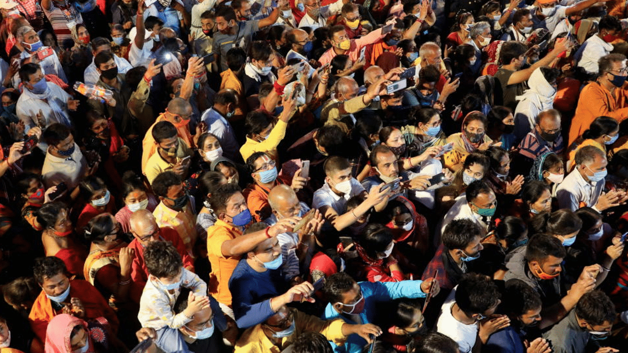 Devotees gather for evening prayer on the banks of the Ganges river during Kumbh Mela, or the Pitcher Festival, amidst the spread of the coronavirus in Haridwar, India, April 13, 2021. Credit: Reuters Photo