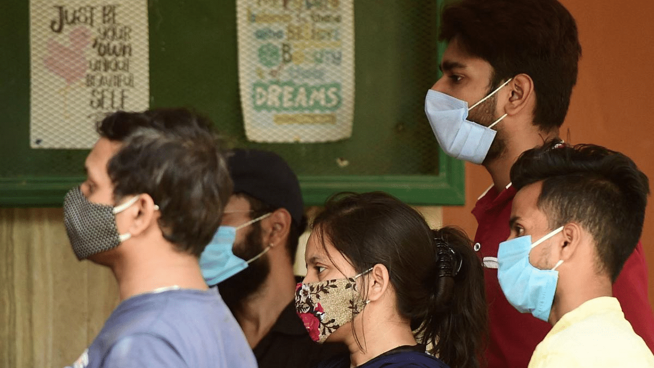 People queue up to get themselves tested for the Covid-19 infection at a testing center in Allahabad. Credit: AFP photo. 