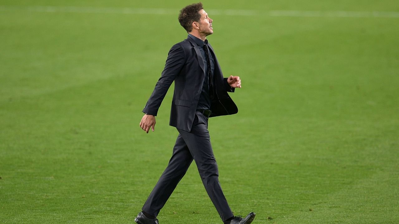 Atletico Madrid's Argentine coach Diego Simeone walks on the pitch at the end of the Spanish League football match between Real Betis and Club Atletico de Madrid at the Benito Villamarin stadium in Seville. Credit: AFP photo