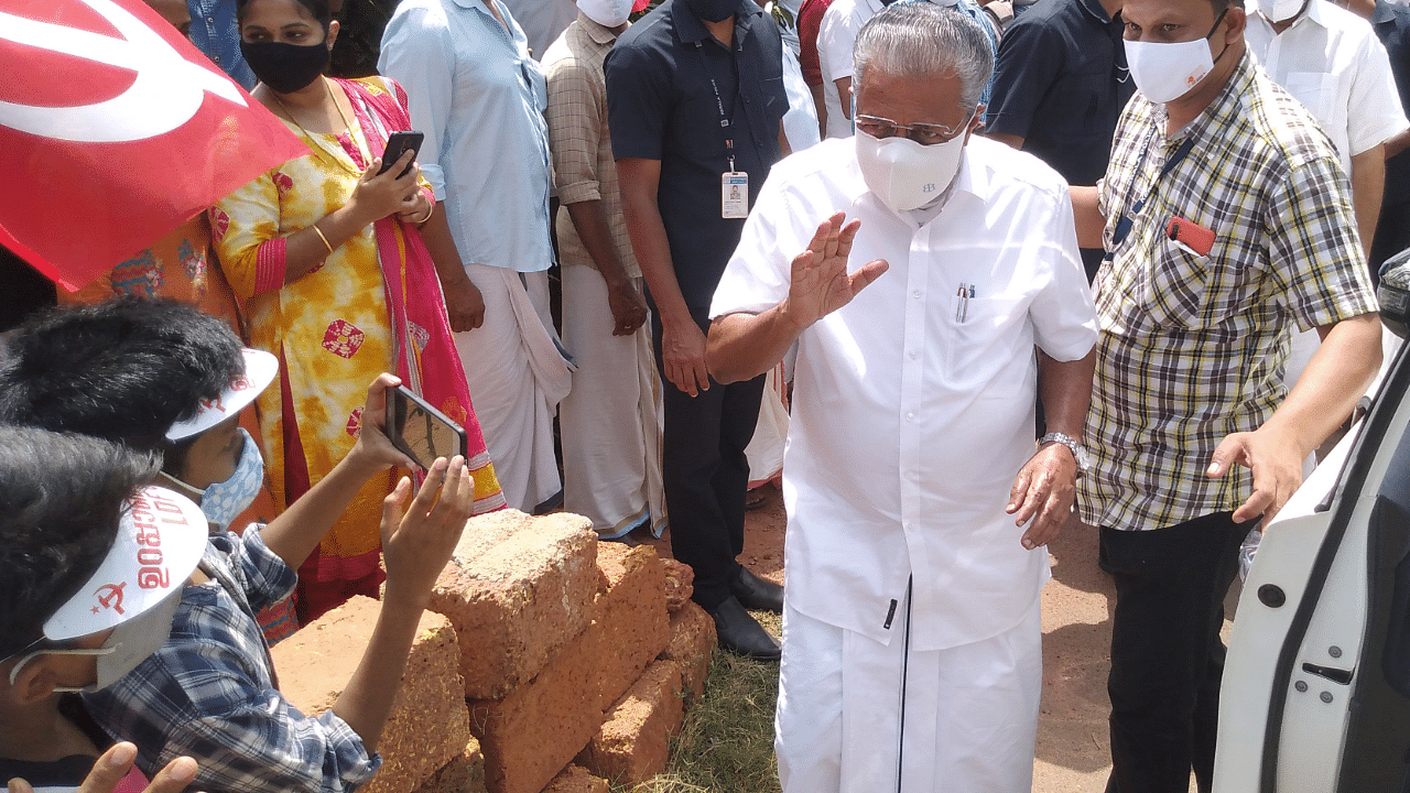 Children to aged persons gather for the campaigns of Vijayan. Vijayan finds time to greet the children and write autographs for them. Credit: DH Photo