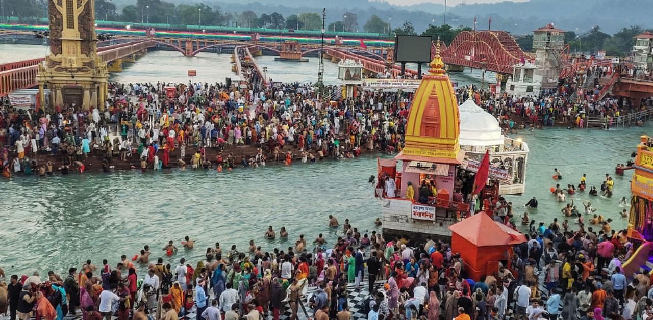 Devotees gather to offer prayers during the third 'Shahi Snan' of the Kumbh Mela 2021, at Har ki Pauri Ghat in Haridwar, Wednesday, April 14, 2021. Credit: PTI Photo