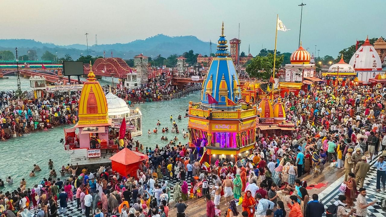 Devotees gather to offer prayers during the third 'Shahi Snan' of the Kumbh Mela 2021, at Har ki Pauri Ghat in Haridwar. Credit: PTI photo