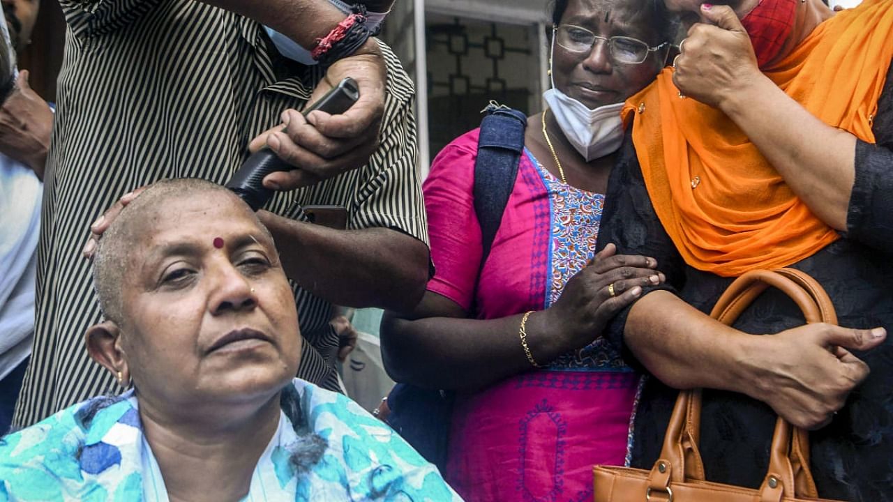 Lathika Subhash tonsured her head in front of the Kerala PCC office after being denied a seat. Credit: PTI file photo.