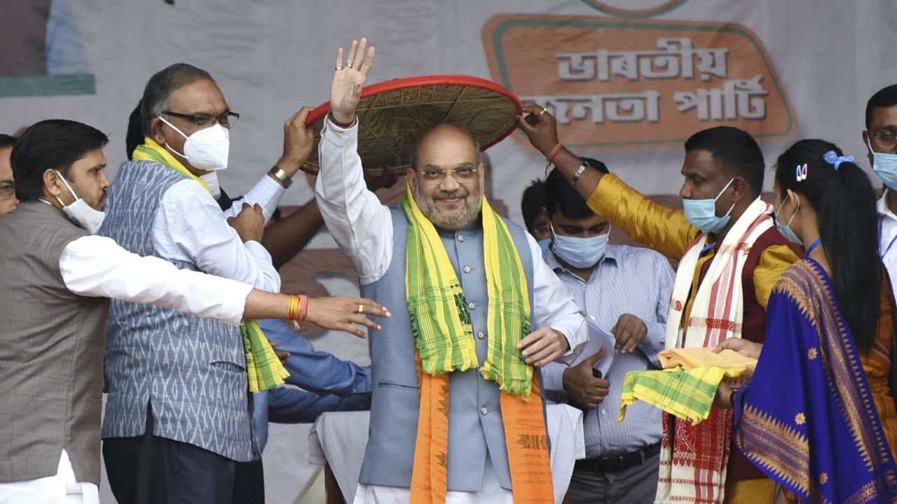 Union Home Minister Amit Shah being felicitated with an 'Assamese Japi' in Bijni. Credit: PTI Photo