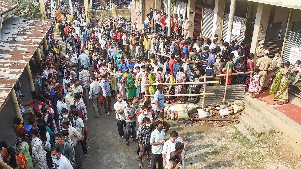 Citizens stand in a queue to cast their votes at a polling station, during the third phase of Assam Assembly elections, in Guwahati, Tuesday, April 6, 2021. Credit: PTI Photo