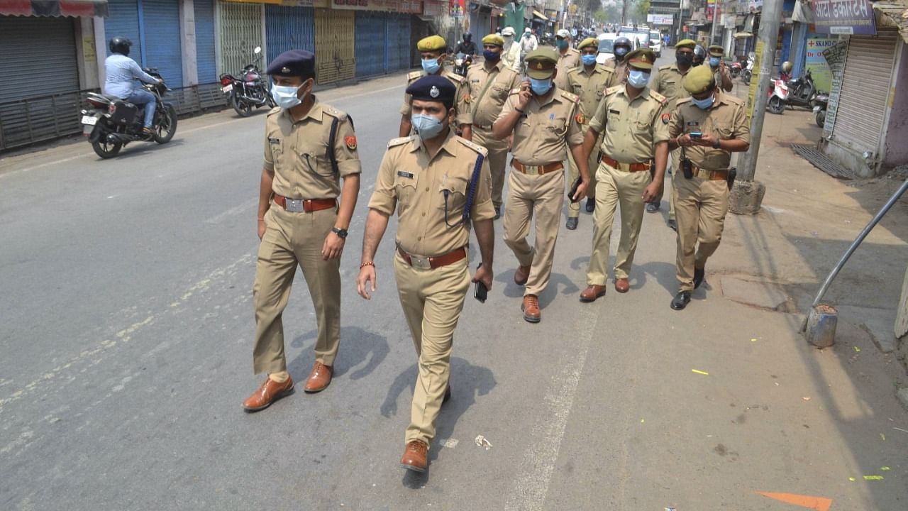 Police personnel march on the street of Varanasi during weekend lockdown imposed the in wake of rising Covid-19 cases across the country, in Varanasi, Saturday, April 17, 2021. Credit: PTI Photo