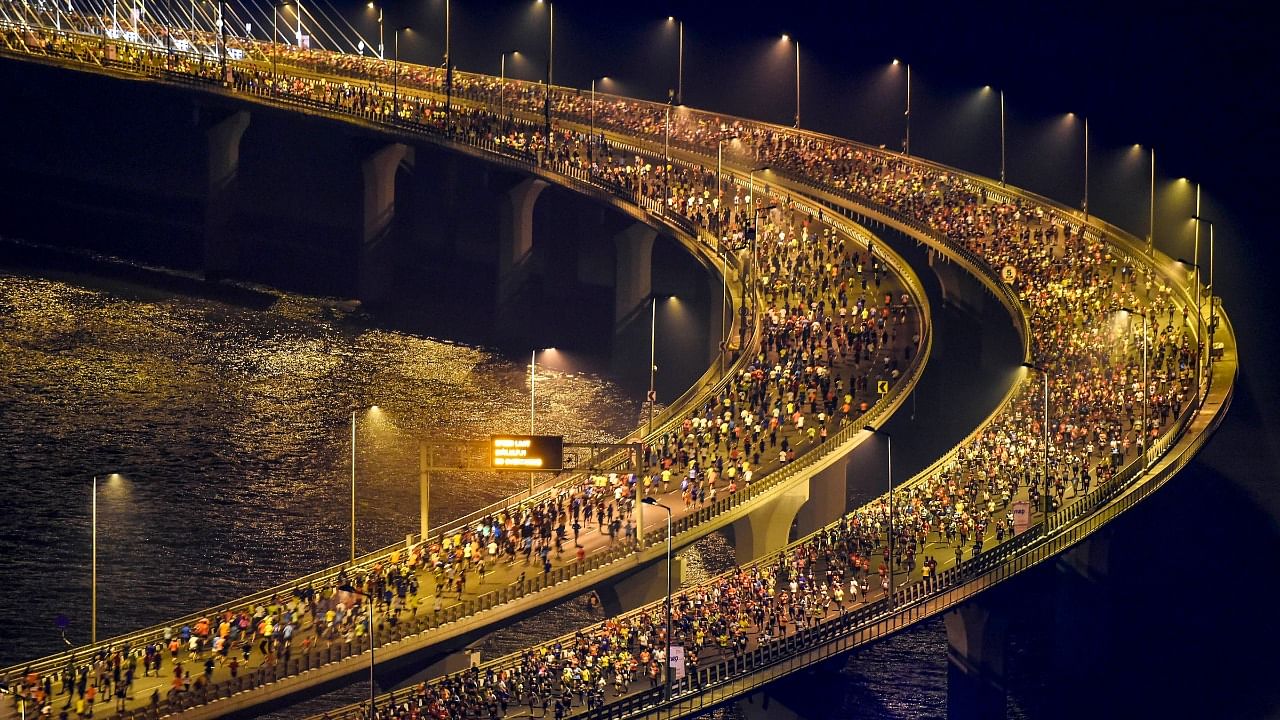 Participants run on the Bandra-Worli Sea Link bridge during the Tata Mumbai Marathon 2020, in Mumbai. Credit: PTI File Photo