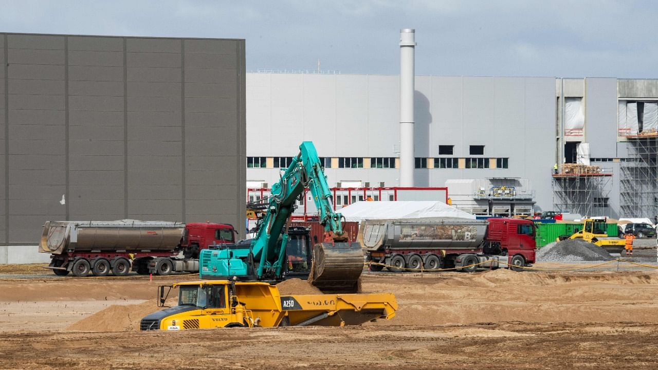 An excavator operates as work continues on US electric car giant Tesla's European "Gigafactory" in Gruenheide, near Berlin on April 8, 2021. Credit: AFP Photo