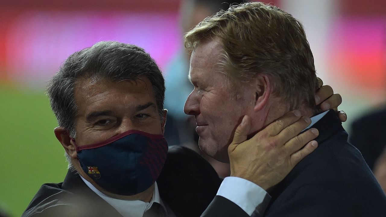 Barcelona's Dutch coach Ronald Koeman (R) celebrates with club president Joan Laporta at the end of the Spanish Copa del Rey (King's Cup) final football match between Athletic Club Bilbao and FC Barcelona at La Cartuja stadium in Seville. Credit: AFP file photo