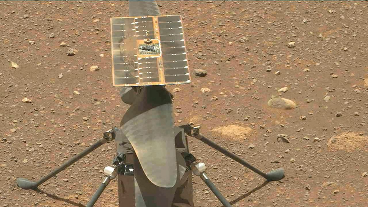 This NASA photo obtained on April 15, 2021 shows NASA's Ingenuity Mars Helicopter's carbon fiber blades can be seen in this video taken by the Mastcam-Z instrument aboard NASA's Perseverance Mars rover on April 8, 2021, the 48th Martian day, or sol, of the mission. Credit: AFP PHOTO / NASA/JPL-Caltech/ASU/HANDOUT