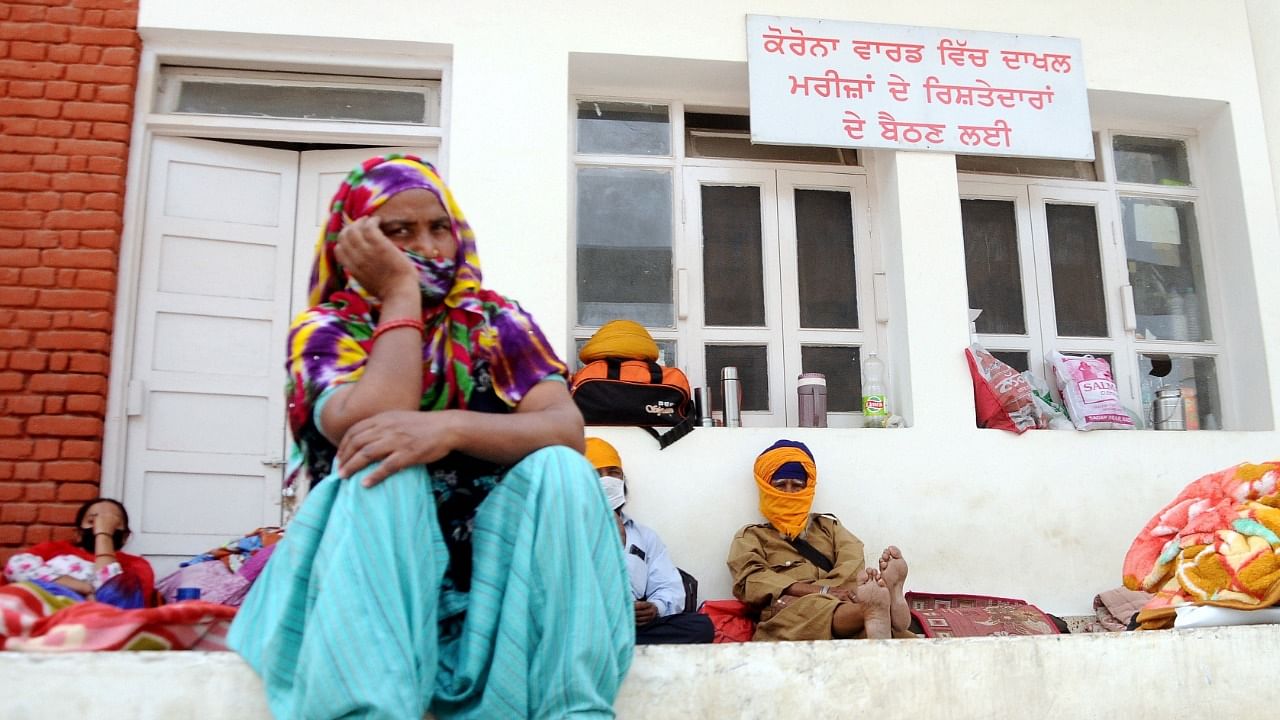 Relatives of Covid-19 patients sitting outside the isolation ward at Rajindra Hospital in Patiala, Saturday, April 17, 2021. Credit: PTI Photo