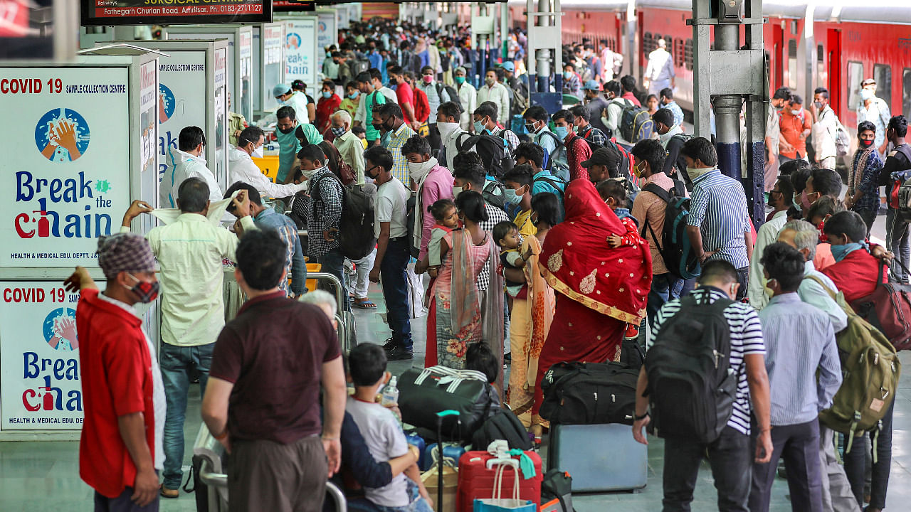 Passengers wait for Covid test upon their arrival at Jammu railway station, amid the rise in Covid-19 cases across the country. Credit: PTI Photo