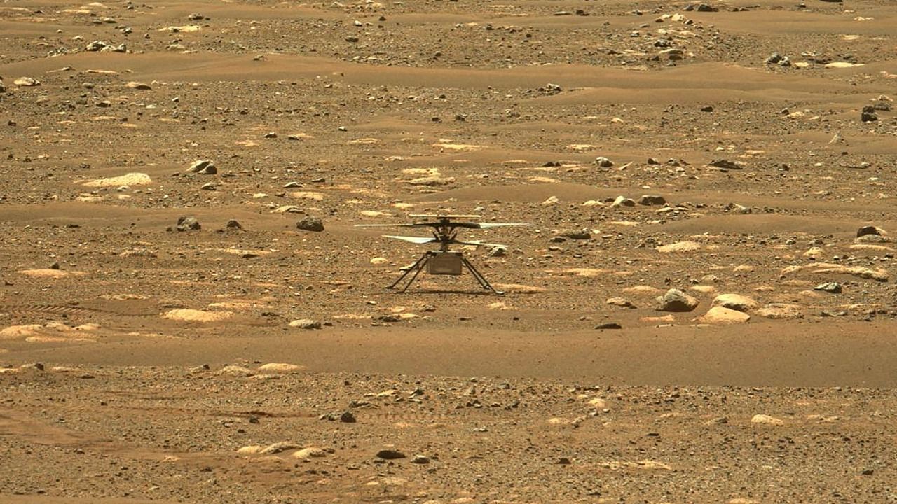 This NASA photo obtained on April 18, 2021 shows the agency's Ingenuity Mars Helicopter right after it successfully completed a high-speed spin-up test, captured by the Mastcam-Z instrument on Perseverance on April 16, 2021 (the 55th sol, or Martian day, of the rover's mission). Credit: AFP Photo