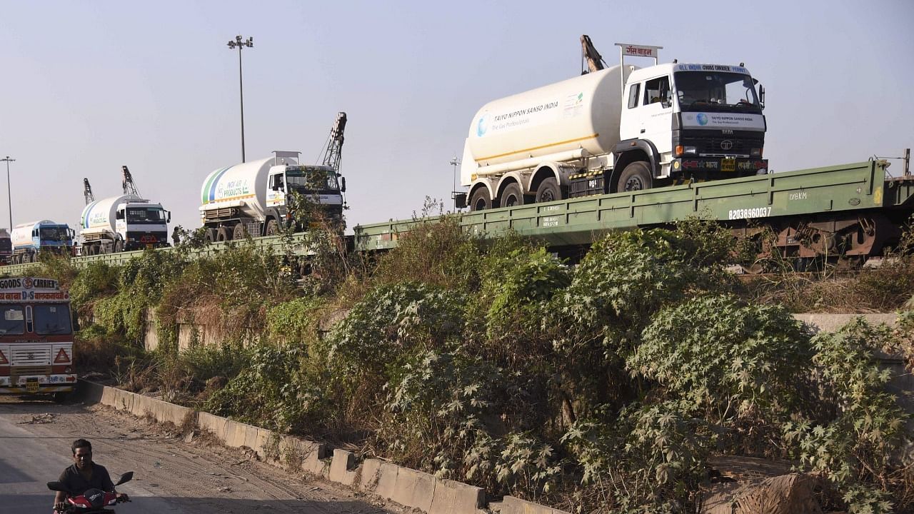 Empty tankers are loaded on a train wagon at the Kalamboli goods yard before being transported to collect liquid medical oxygen. Credit: PTI Photo