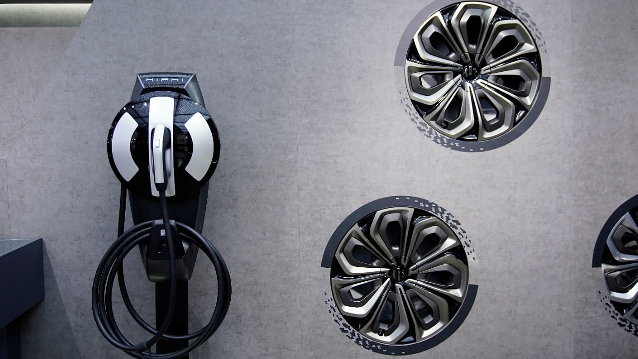 An electric vehicle (EV) charging point and wheels are seen displayed at the HiPhi booth during a media day for the Auto Shanghai show in Shanghai, China April 20, 2021. Credit: Reuters Photo