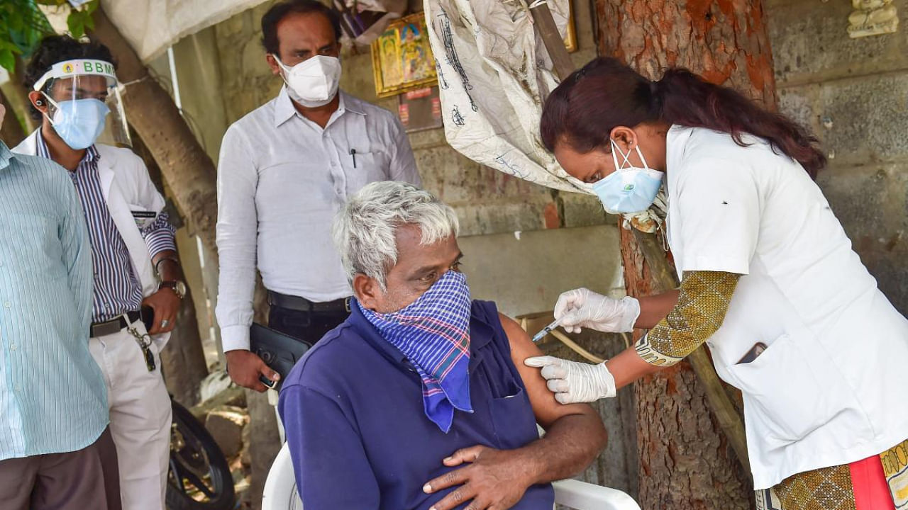 A medic administers the Covid-19 vaccine amid surge in coronavirus cases in Bengaluru. Credit: PTI photo.
