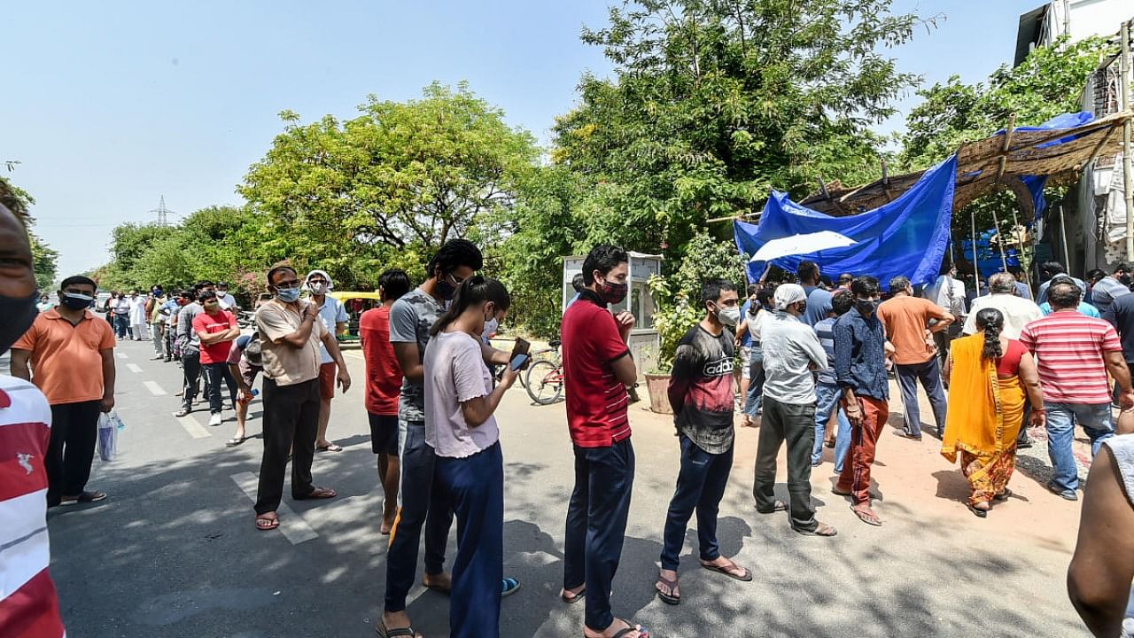  People stand in queue for Covid-19 testing, amid the rise in Covid-19 cases across the country, in Ghaziabad. Credit: PTI Photo