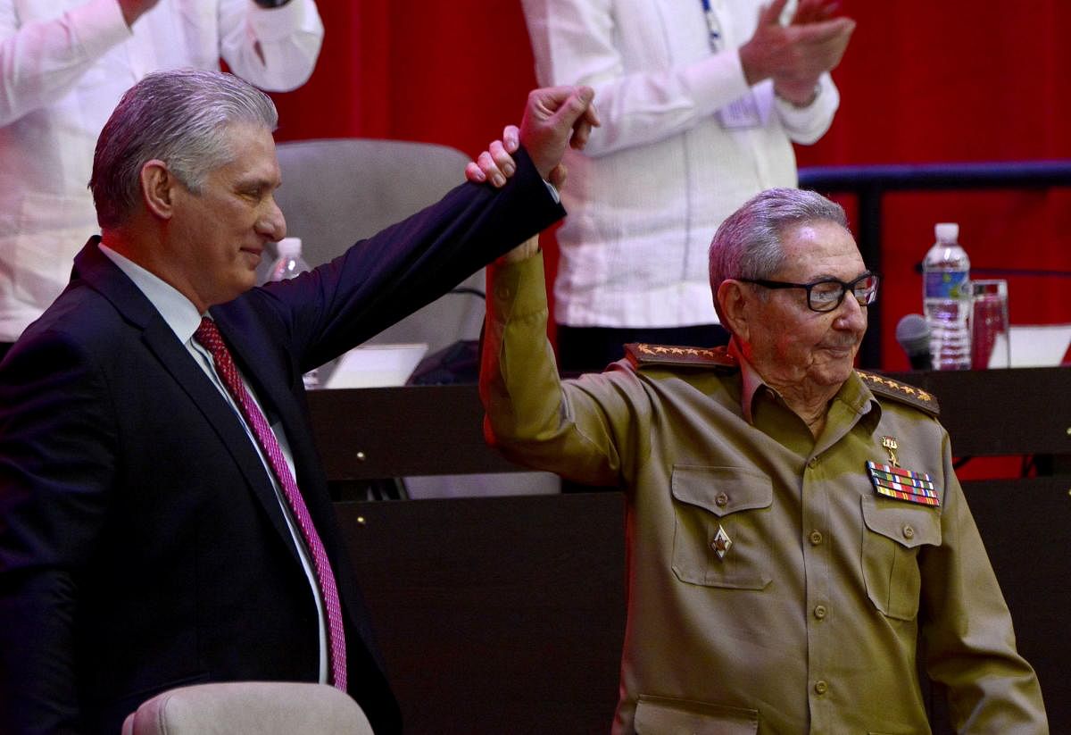 Cuba's President and newly-elected First Secretary of the Communist Party Miguel Diaz-Canel reacts as former Cuban President and First Secretary of the Communist Party Raul Castro raises his hand during the closing session of the VIII Congress of the Communist Party in Havana, Cuba. Credit: Reuters photo. 