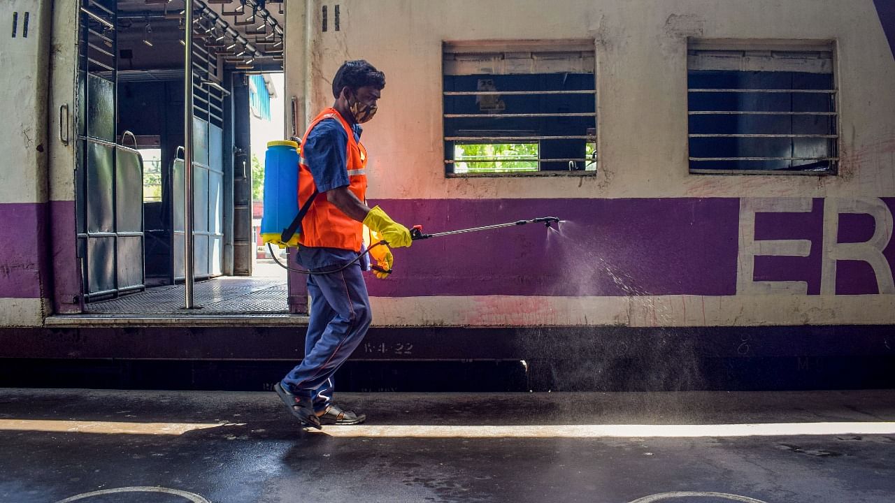 A health worker sanitizing a railway platform during Covid-19 pandemic, in West Bengal's Nadia district. Credit: PTI Photo