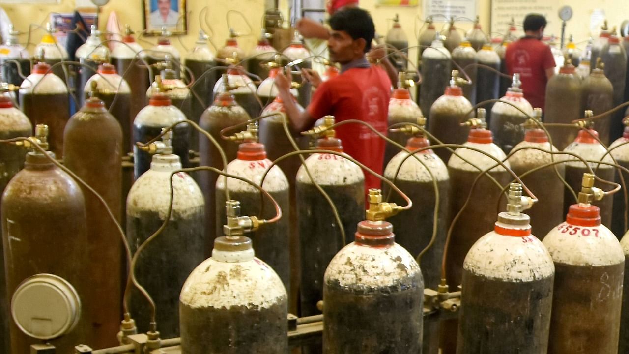 Workers fill cylinders with medical oxygen at a plant, required for treatment of Covid-19 patients, amid a countrywide surge in cases, in Amravati, Monday, April 19, 2021. Credit: PTI Photo