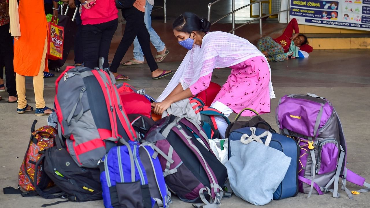 Passengers wait at City Railway Station to go to their respective native places, amid surge in coronavirus cases in Bengaluru, Monday, April 20, 2021. Credit: PTI Photo