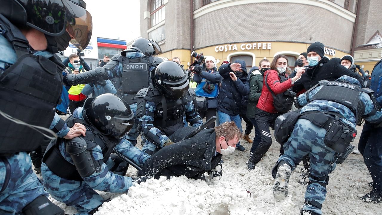 Law enforcement officers detain a protestor during a rally in support of Alexei Navalny. Credit: Reuters Photo