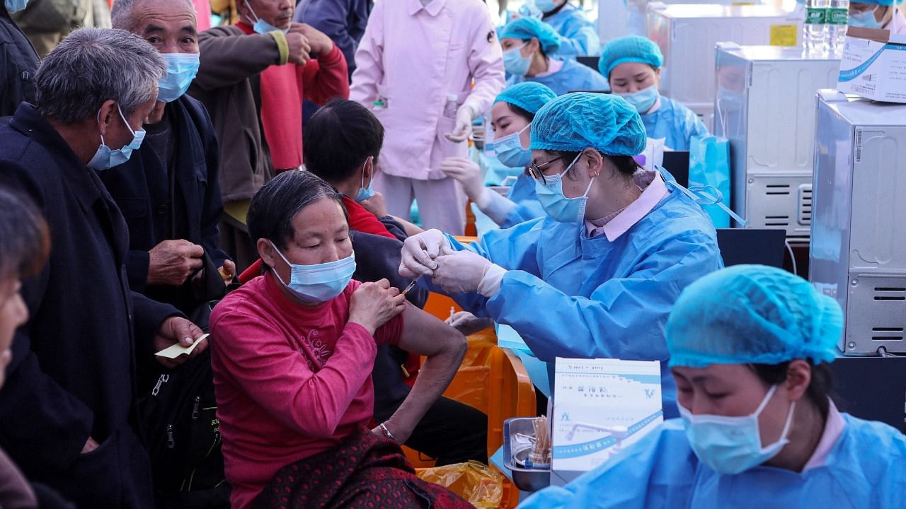 China administered around 3.3 million doses a day on average in the past seven days till Monday. Credit: AFP File Photo