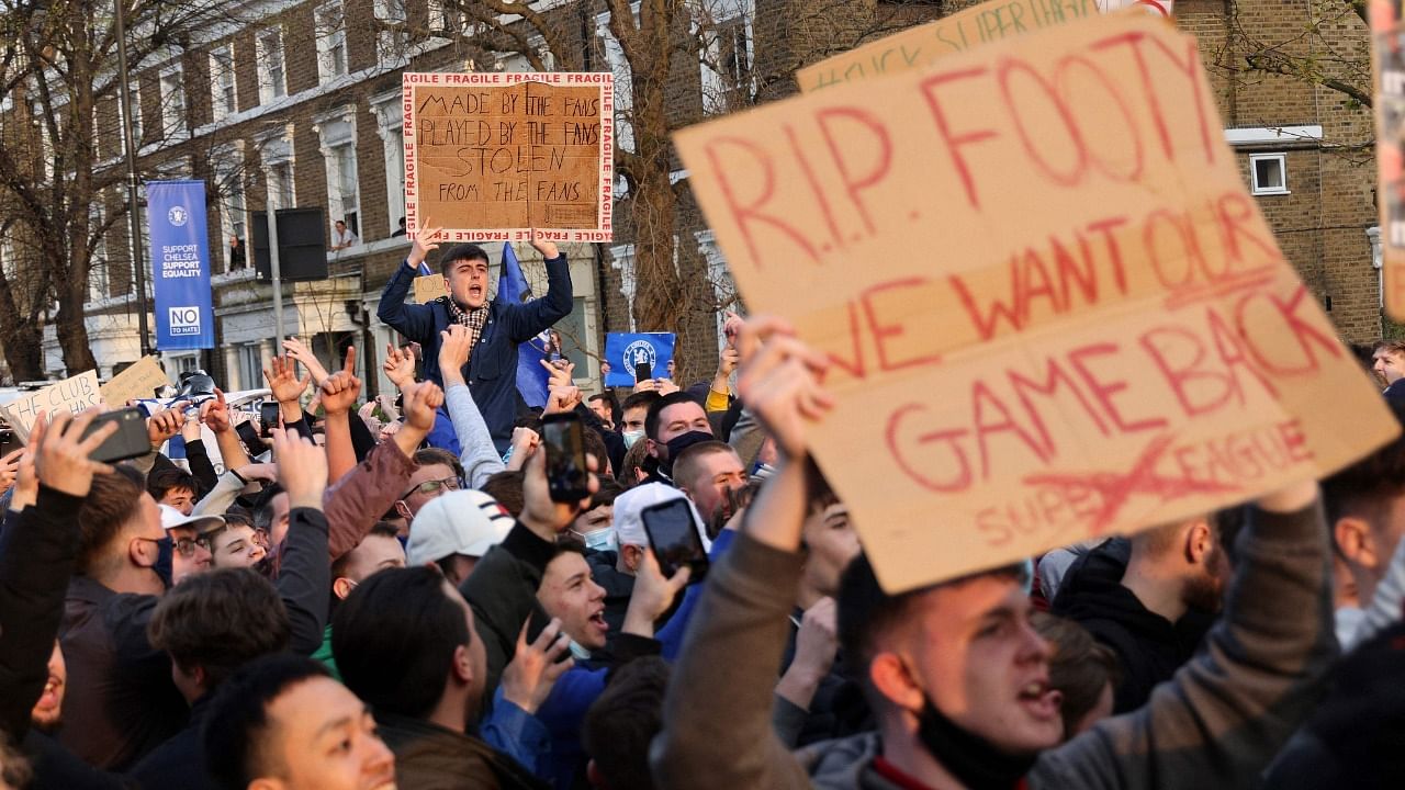 Football supporters demonstrate against the proposed European Super League outside of Stamford Bridge football stadium in London on April 20, 2021, ahead of the English Premier League match between Chelsea and Brighton and Hove Albion. Credit: AFP Photo