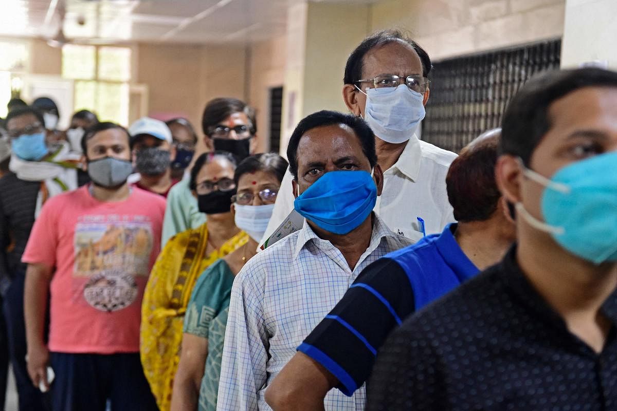 People queue at a Covid-19 vaccine centre in Bengaluru. Credit: DH Photo. 