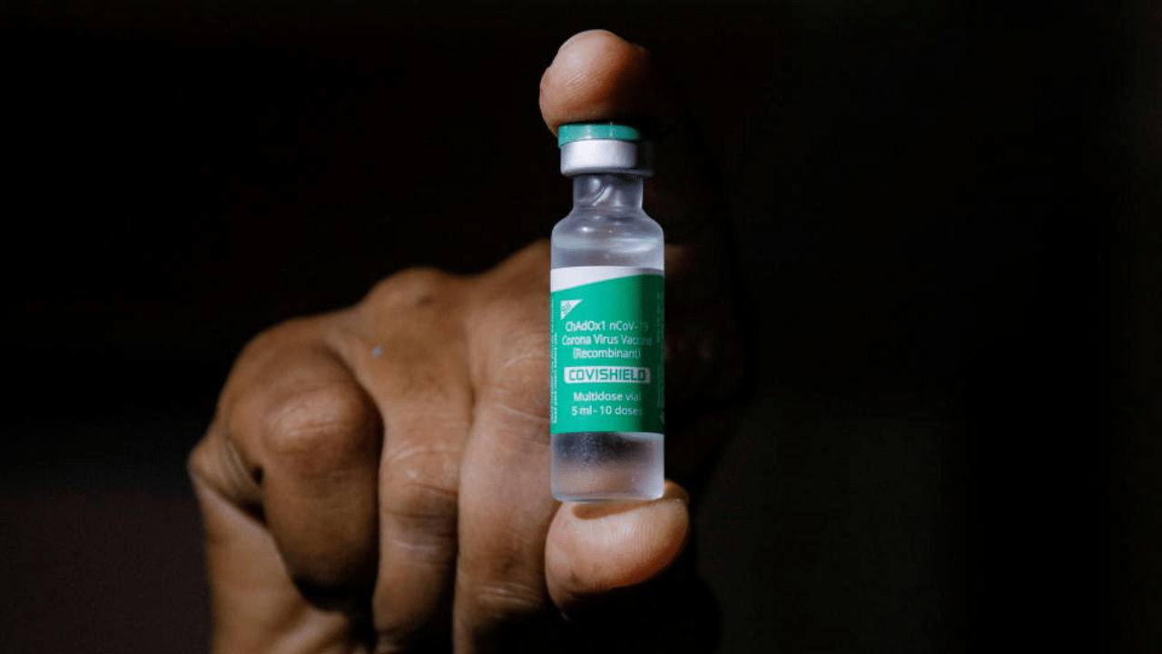 A man displays a vial AstraZeneca's COVISHIELD vaccine. Credit: Reuters File Photo