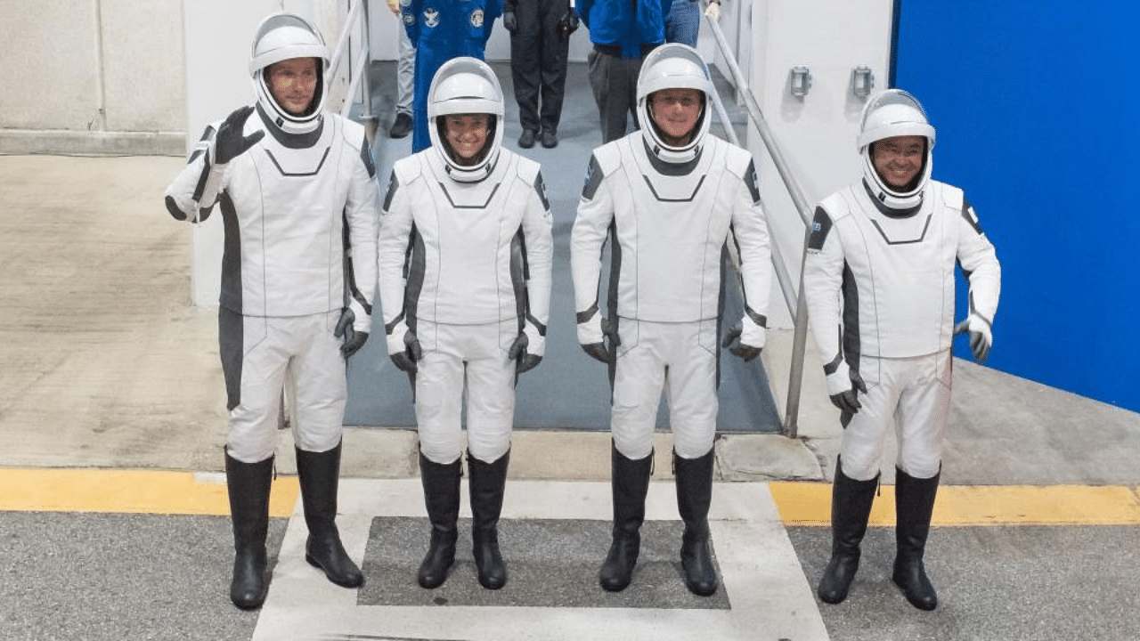 This handout photo released by NASA and taken on April 18, 2021 shows (from L) ESA (European Space Agency) astronaut Thomas Pesquet, NASA astronauts Megan McArthur and Shane Kimbrough, and Japan Aerospace Exploration Agency (JAXA) astronaut Akihiko Hoshide, wearing SpaceX spacesuits as they prepare to depart the Neil A. Armstrong Operations and Checkout Building for Launch Complex 39A during a dress rehearsal prior to the Crew-2 mission launch, at NASA's Kennedy Space Center in Florida. Credit: AFP 