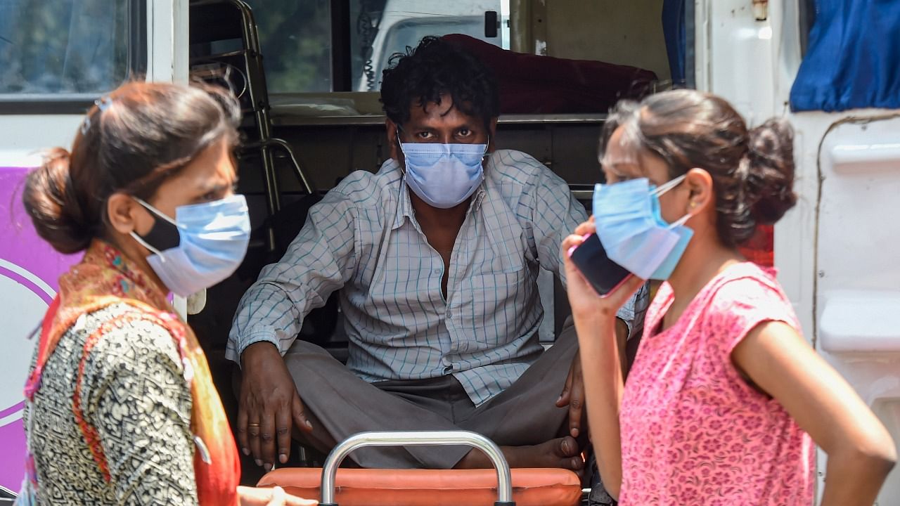  A Covid-19 patient in an ambulance outside Lok Nayak Jaiprakash Narayan Hospital, as coronavirus cases spike in New Delhi. Credit: PTI Photo