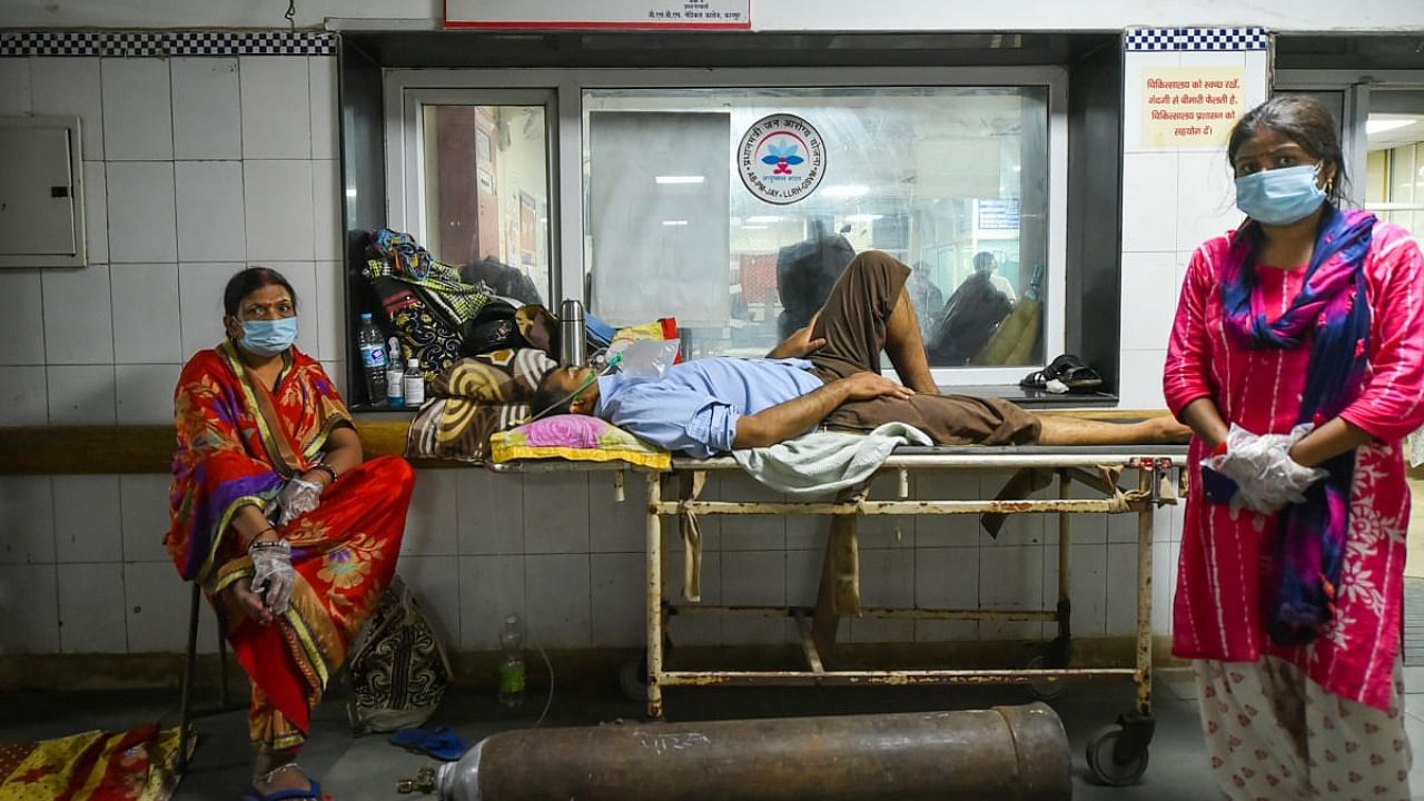 Covid-19 patient on a stetcher waits to be allocated a bed at LLR Hospital, amid a shortage in supplies due to surge in coronavirus cases in record numbers across the country, in Kanpur. Credit: PTI Photo