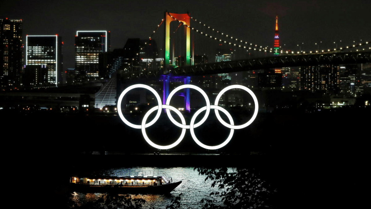 The Rainbow Bridge and Tokyo Tower illuminated with Olympic colours. Credit: Reuters file photo.