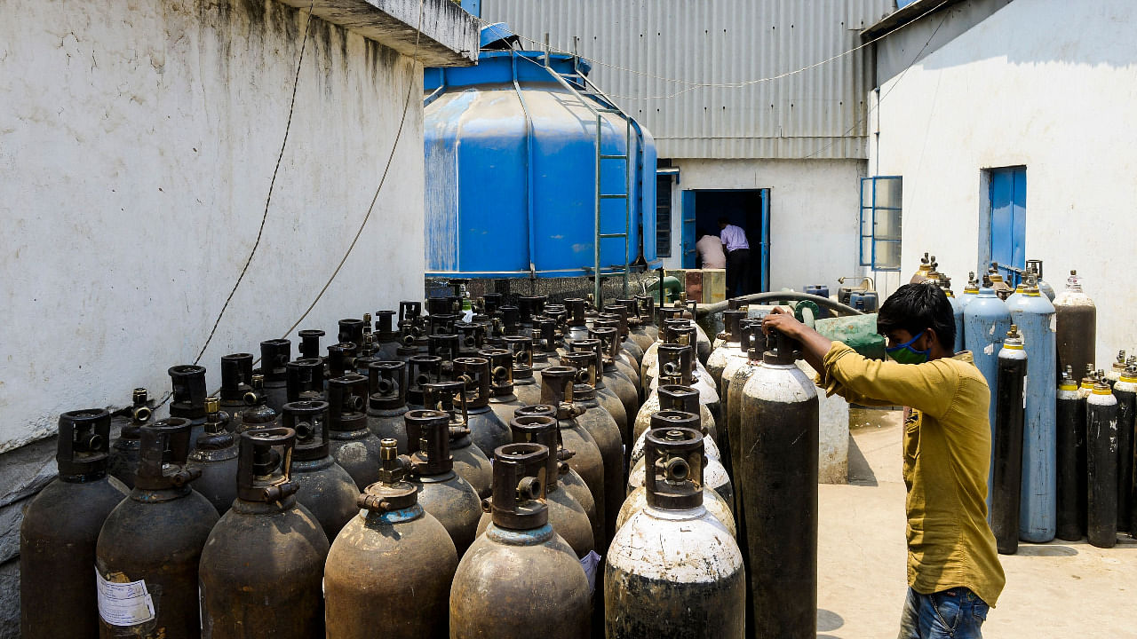 A worker arranges medical oxygen cylinders to transport to hospitals for the Covid-19 treatment in Hyderabad. Credit: AFP Photo