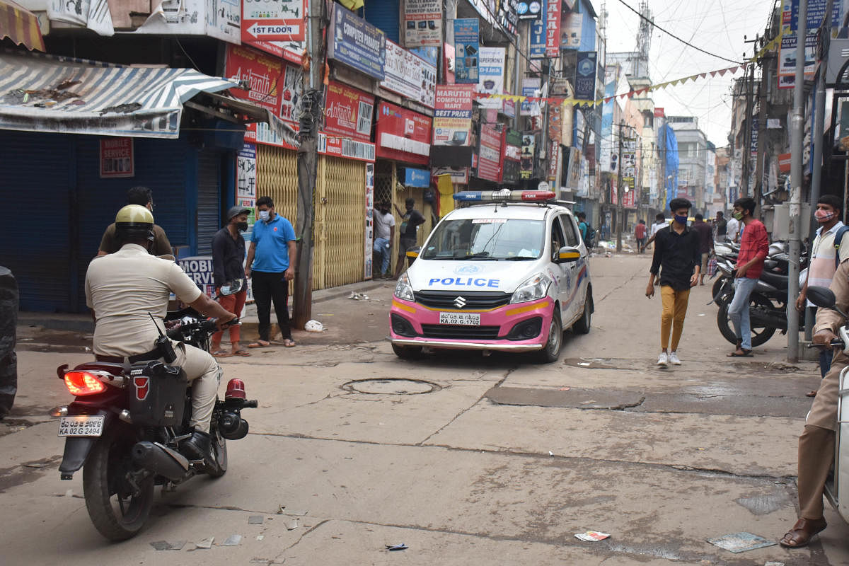 Police announce the closure of shops on S P Road in Bengaluru following the release of guidelines from the government on Thursday. DH photo/B K Janardhan