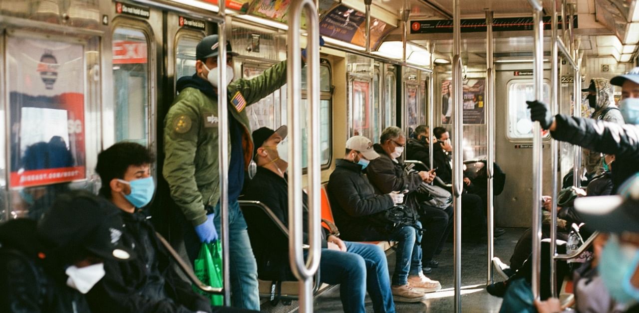 NYC commuters wear face masks while riding the subway amidst the pandemic. Credit: iStock Photo