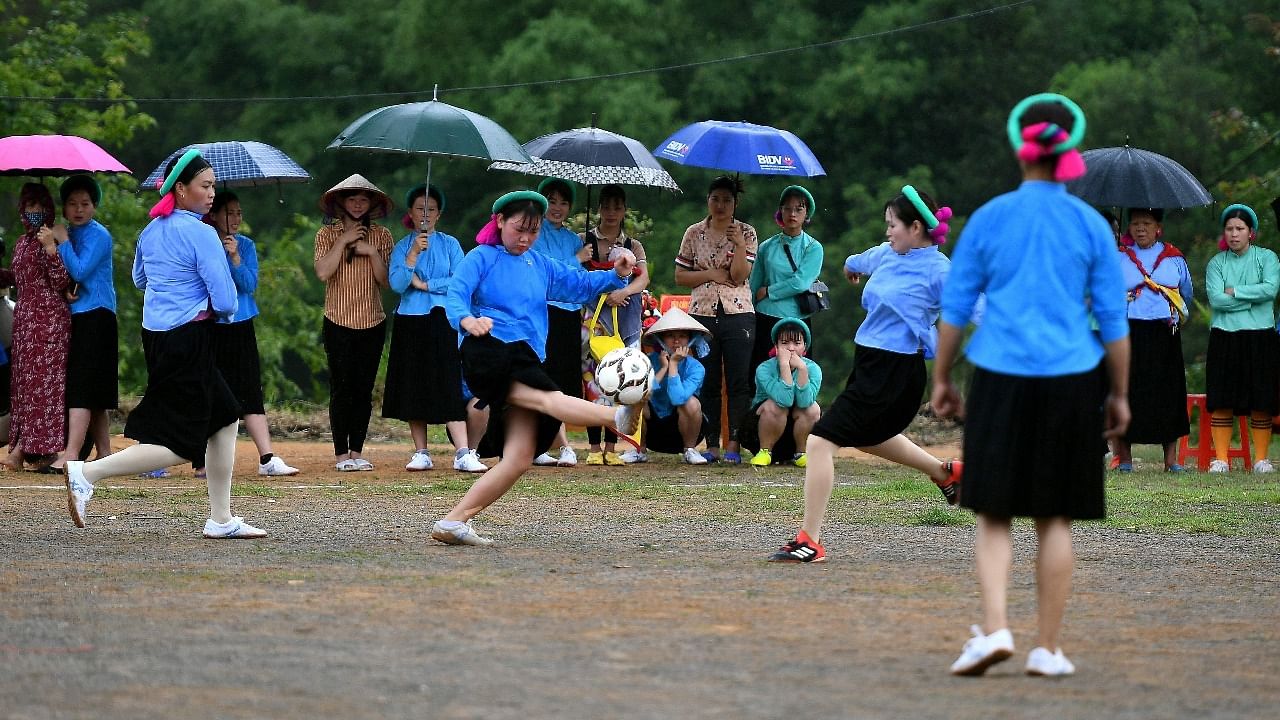 Ethnic San Chi women dressed in traditional costumes play a friendly football match as part of the Soong Co festival celebrations in northern Vietnam's Quang Ninh province. Credit: AFP Photo