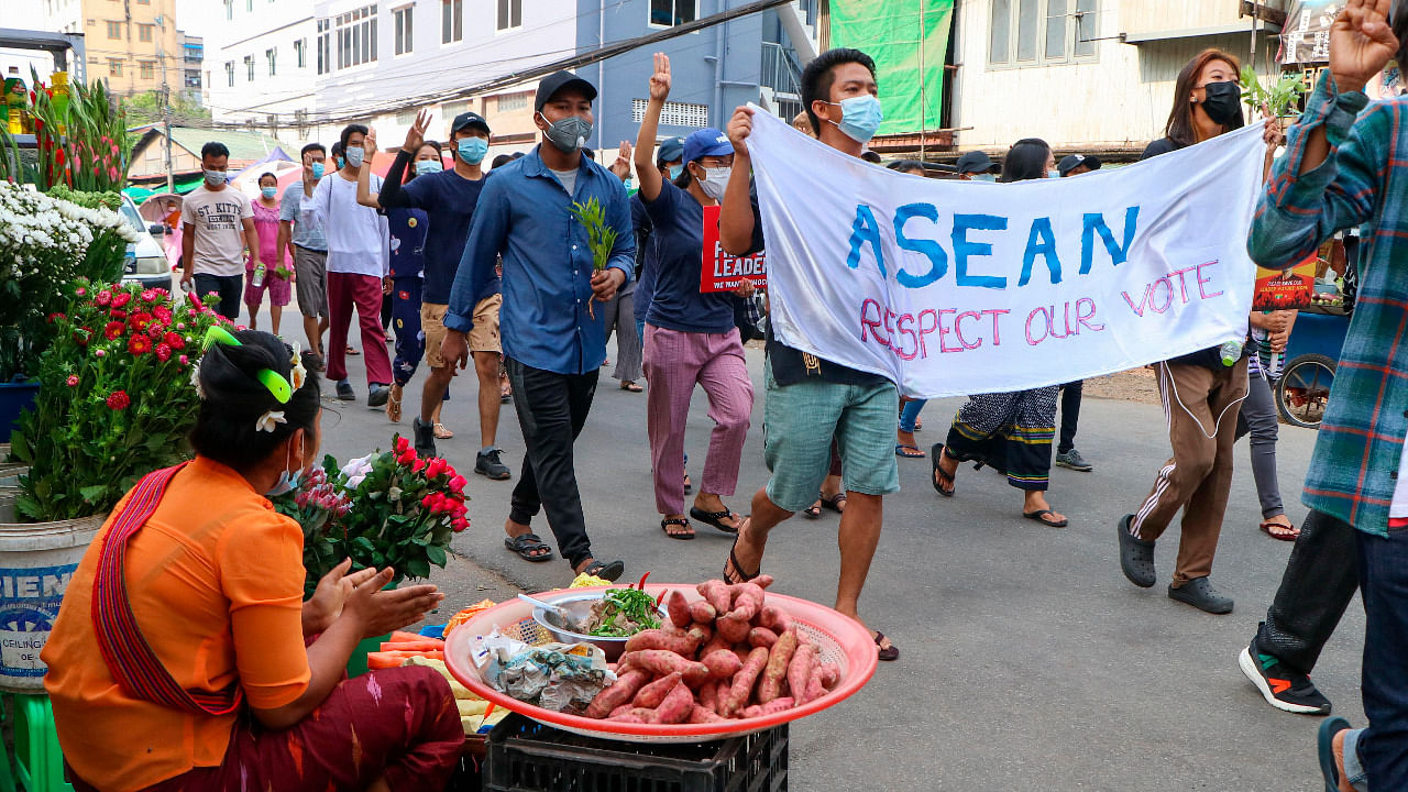 Anti-coup protesters hold a banner which reads ASEAN Respect our Vote as they march on a street in Yangon, Myanmar. Credit: AP Photo