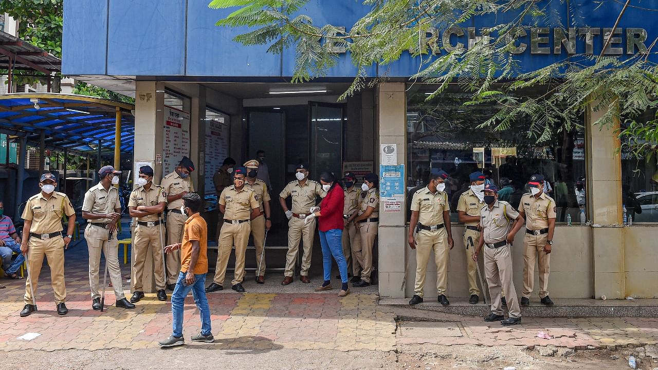 Police personnel stand outside the Vijay Vallabh Covid care hospital after a fire in Virar West, on the outskirts of Mumbai, Friday, April 23, 2021. Credit: PTI Photo