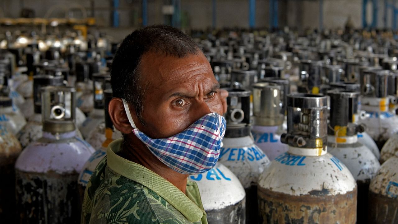 Workers are seen sorting oxygen cylinders that are being used for Covid-19 coronavirus patients before dispatching them to hospitals at a facility in Bengaluru on April 19, 2021. Credit: AFP Photo