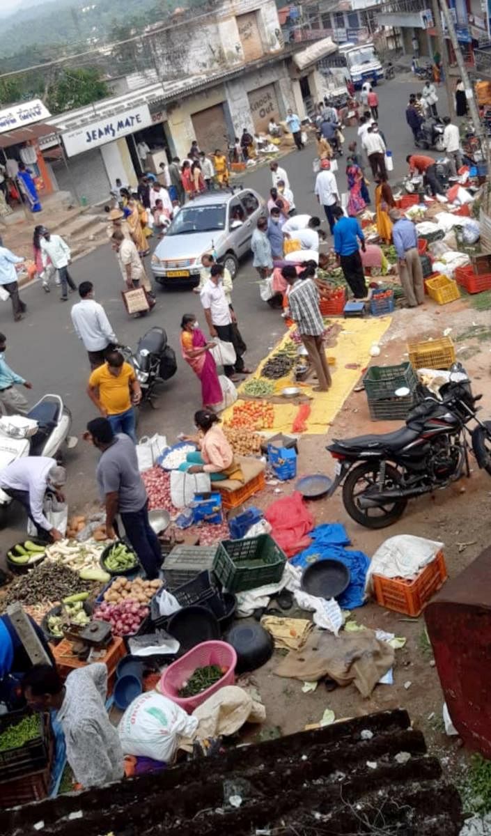 Vendors sell vegetables on the roadside, in Somwarpet town, on the day of the weekly shandy, on Monday.